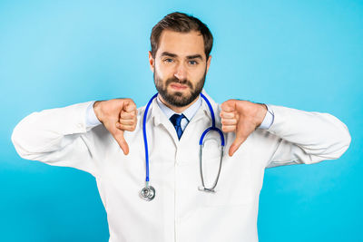 Mid adult man standing against blue background