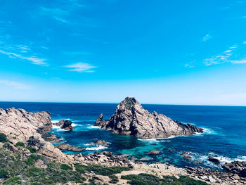 Scenic view of sea against blue sky