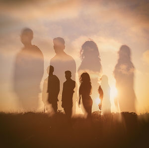 Silhouette people against sky during sunset