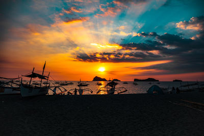 Scenic view of beach against sky during sunset