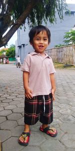 Portrait of cute boy standing outdoors