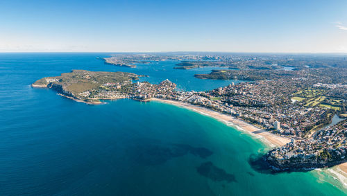 High angle view of sea and city against sky