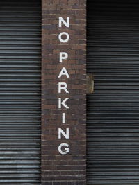 Close-up of text on brick wall