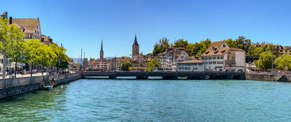 View from the muehlsteg on the limmatquai and the church fraumuenster in zurich, switzerland