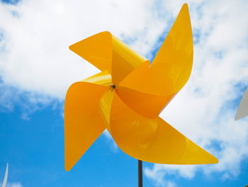 Low angle view of yellow toy against sky