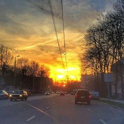 Cars on road at sunset