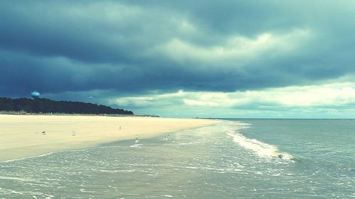 Scenic view of sea against cloudy sky