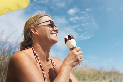 Smiling woman having ice-cream