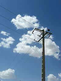 Low angle view of telephone line against blue sky