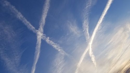 Low angle view of vapor trails in sky