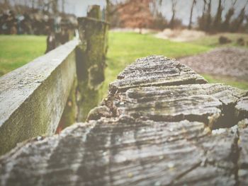 Close-up of wooden fence on field