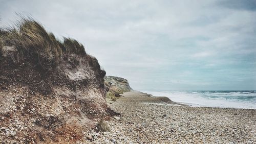 Scenic view of sea against cloudy sky