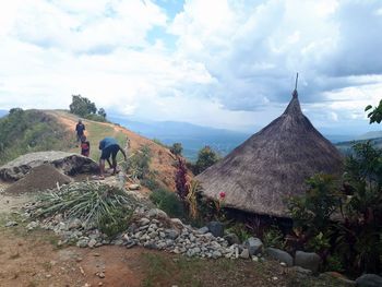 People on mountain against sky