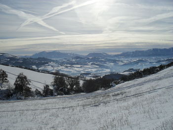 Scenic view of snow covered mountains against sky