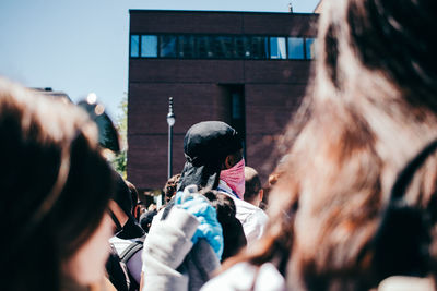 Rear view of people in front of building