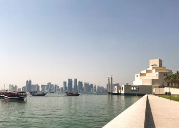 Buildings in city against clear sky