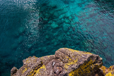 High angle view of rock by sea