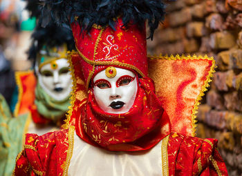 Portrait of woman wearing mask and costume outdoors