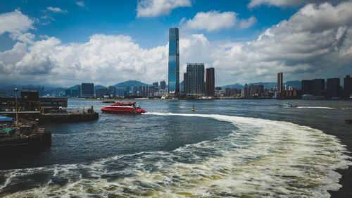 Panoramic hong kong cityscape against cloudy sky