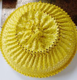 High angle view of yellow flower on table