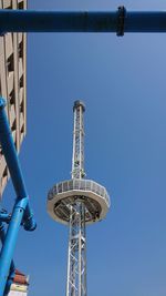 Low angle view of ferris wheel against clear blue sky