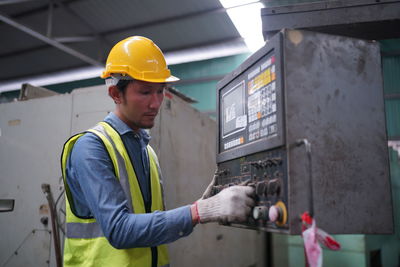 Rear view of man working at construction site