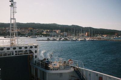 Boats in sea against clear sky