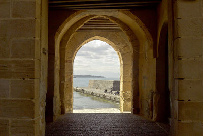 Archway of historic building against sky