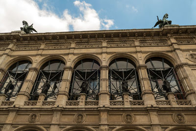 Low angle view of building against cloudy sky