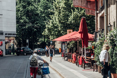 People walking on road in city