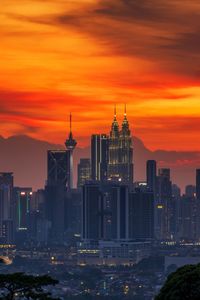 Buildings in city during sunset