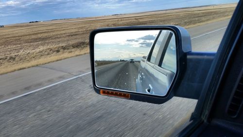 Reflection of car on side-view mirror