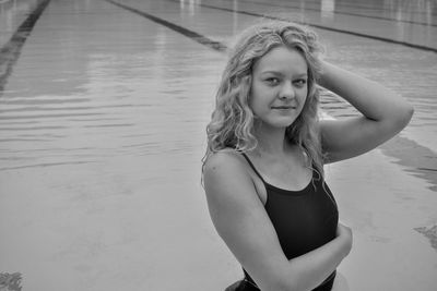 Portrait of a smiling young woman standing in water