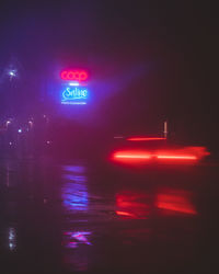 Close-up of road sign at night