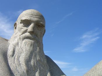 Low angle view of sculpture against blue sky