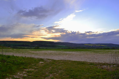 Scenic view of field against sky during sunset