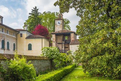 Trees and old building against sky