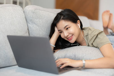 Young woman using laptop at home