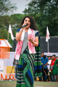 Young woman singing during festival