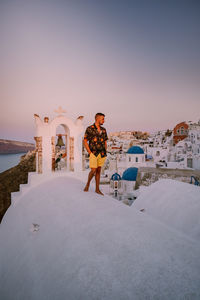 Full length of man standing on building against sky