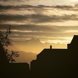 Low angle view of silhouette person against sky during sunset