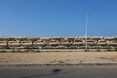 Built structure on land against clear blue sky