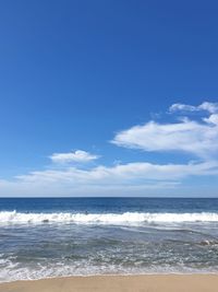 Scenic view of sea against blue sky