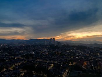 High angle view of city buildings against sky during sunset
