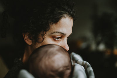 Contemplating mother holding baby boy