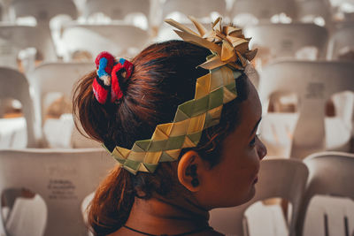 Portrait of girl wearing headgear made from leafs. 