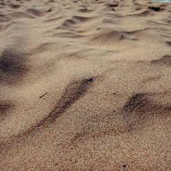 High angle view of footprints on sand at beach