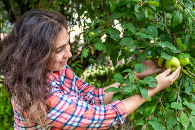 Woman looking at fruits on tree