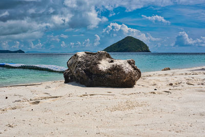 Rocks on beach against sky