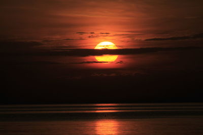 Scenic view of sea against orange sky